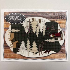 Pattern cover for Primitive Gatherings' 'Santa's Journey' table mat featuring wool applique winter scene with sleigh-riding Santa, forest animals, snowy evergreens, and folk art details on dark plaid background, sized 18&frac12;x28 inches