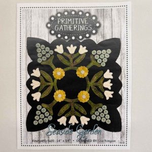 Pattern cover for Primitive Gatherings' 'Seaside Garden' wool applique table mat by Lisa Bongean featuring folk art floral design with cream tulips, golden daisies, sage penny flowers, and detailed leaf stems on black wool background, sized 14x14 inches
