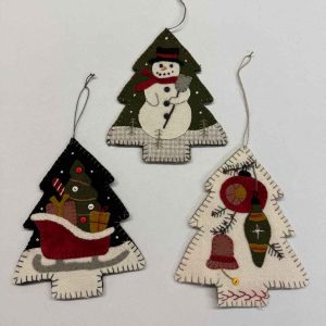 Set of three vintage-style Christmas tree wool applique ornaments featuring snowman with red scarf, Santa's sleigh with presents, and traditional ornaments on cream wool with blanket-stitch edges